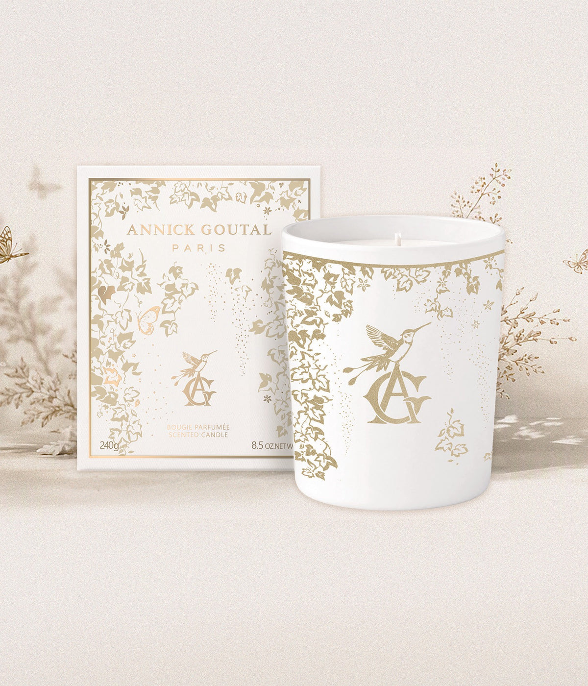Annick Goutal Duftkerze Noël — Une Forêt d’Or mit Verpackung vor goldenen Zweigen