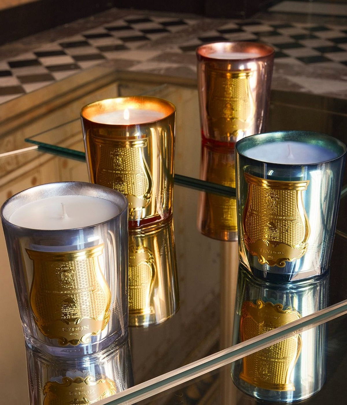 Trudon Cabinet des Miroirs, Galerie des Flammes, Nazareth and Fir scented candles on a mirror above a checkered floor